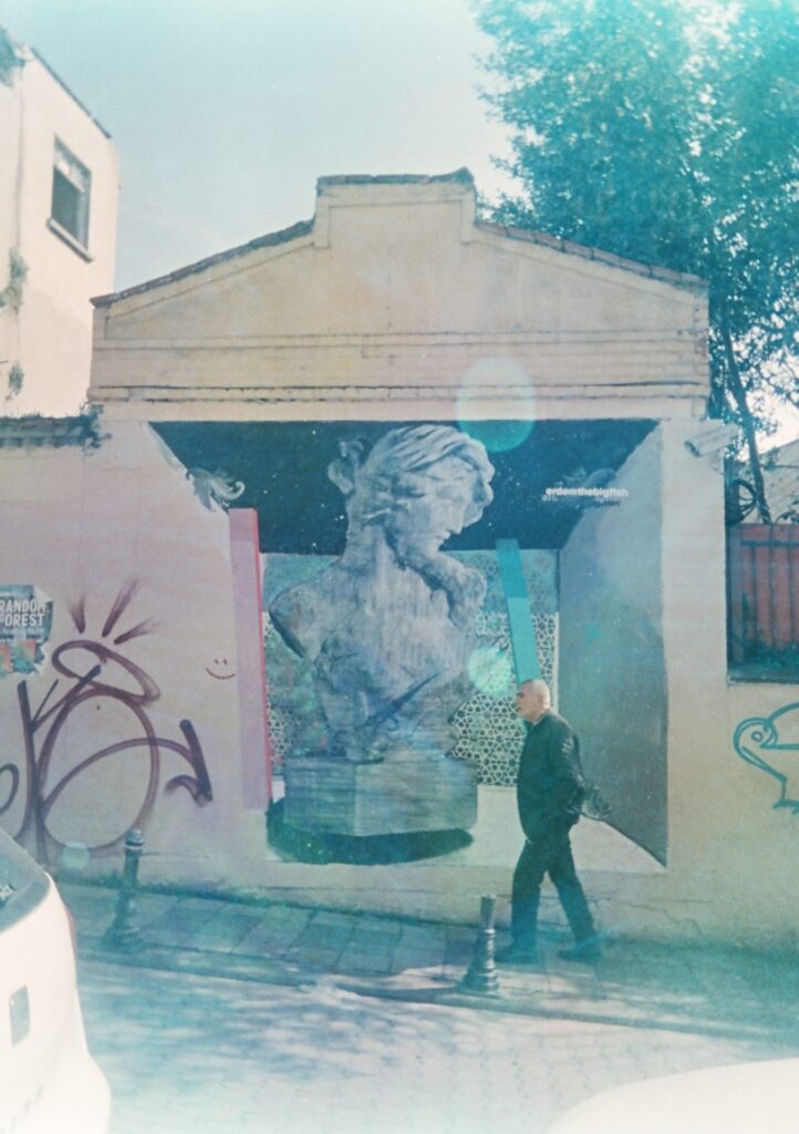 A man walks in front of street art outside the old Jewish synagogue in Kadıköy