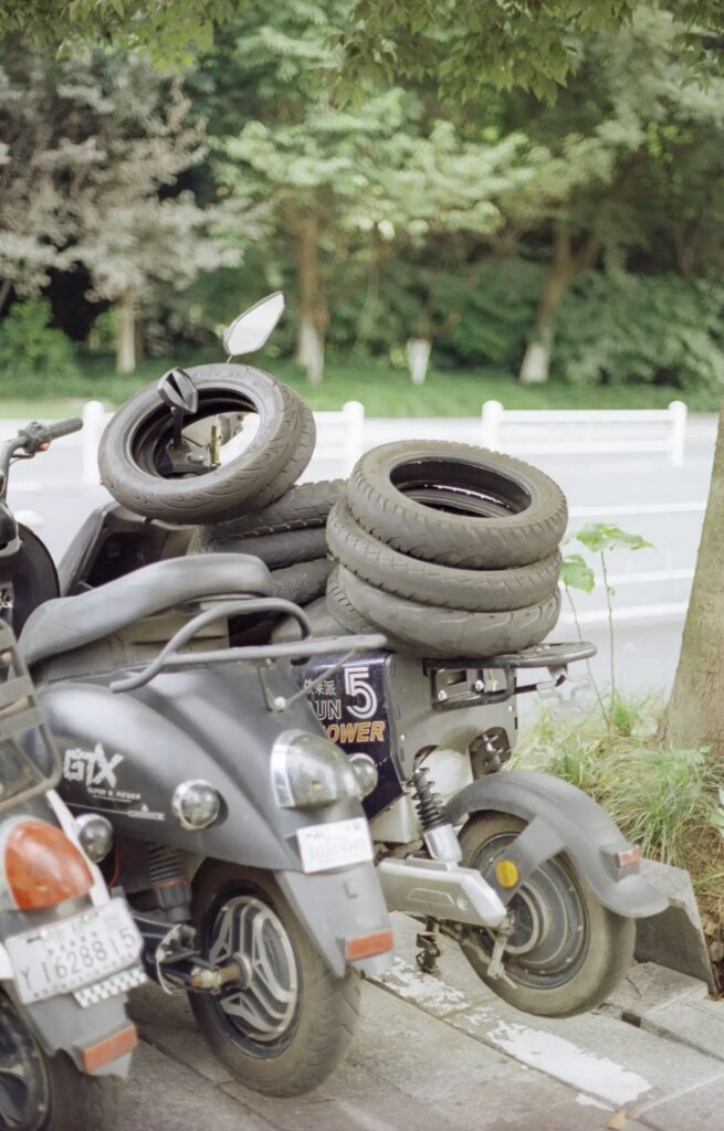 An ebike with old tires stacked on top of it stands at the bicycle station in Hangzhou, China