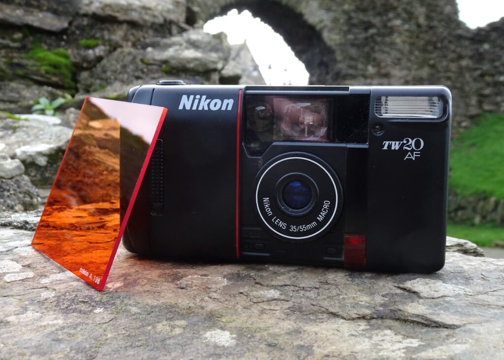 Nikon TW20 on stone wall with orange filter. Castle ruin in background