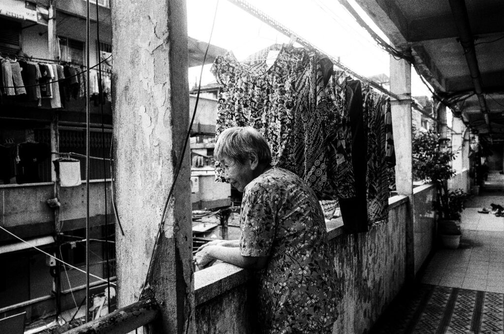 An elderly resident of Saigon's oldest apartment block, Nguyen Thien Thuat, built in 1968. Fortunately I was accompanied by a translator who asked the lady if it was ok to make a photograph of her; she seemed happy we were there and interested in the history of the neighbourhood.