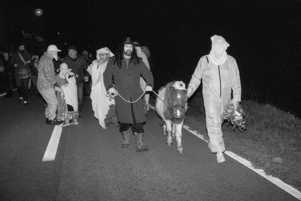 Participants in the "Encamisada" parading through the streets of the village.