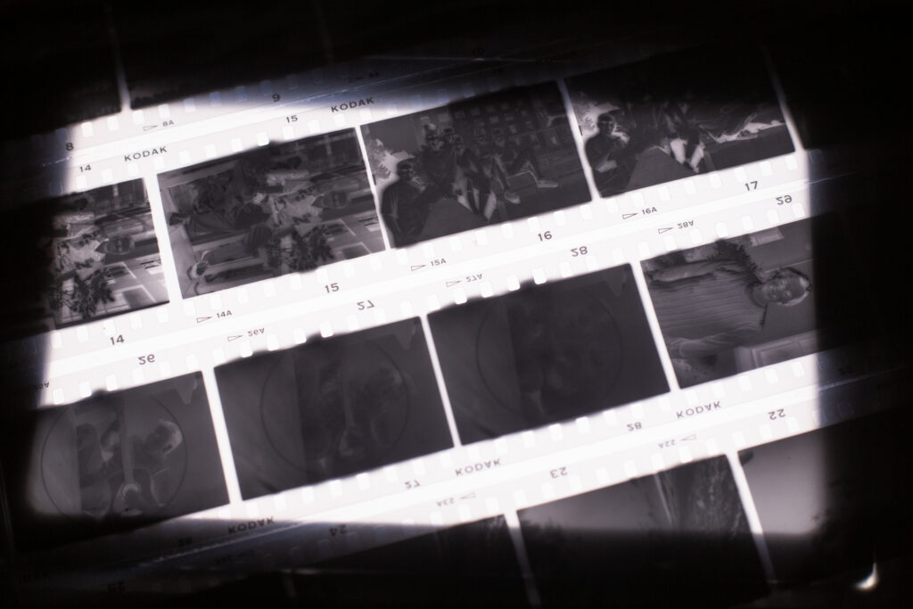Closeup of Kodak HIE negatives over a light table, show light bleed and bloom past the camera's film gate.