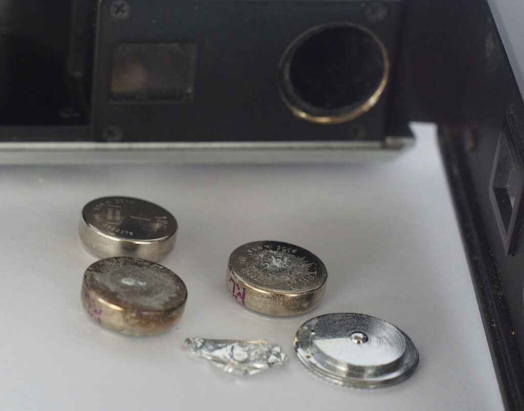 Corroded batteries and scrap of foil that was in the camera.