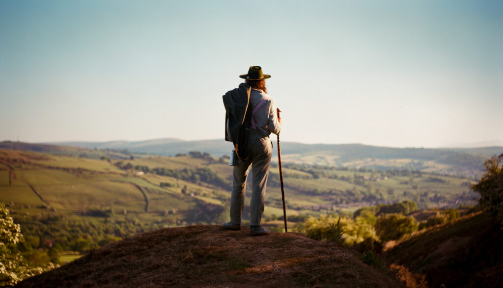 A man looking out over distant hills.