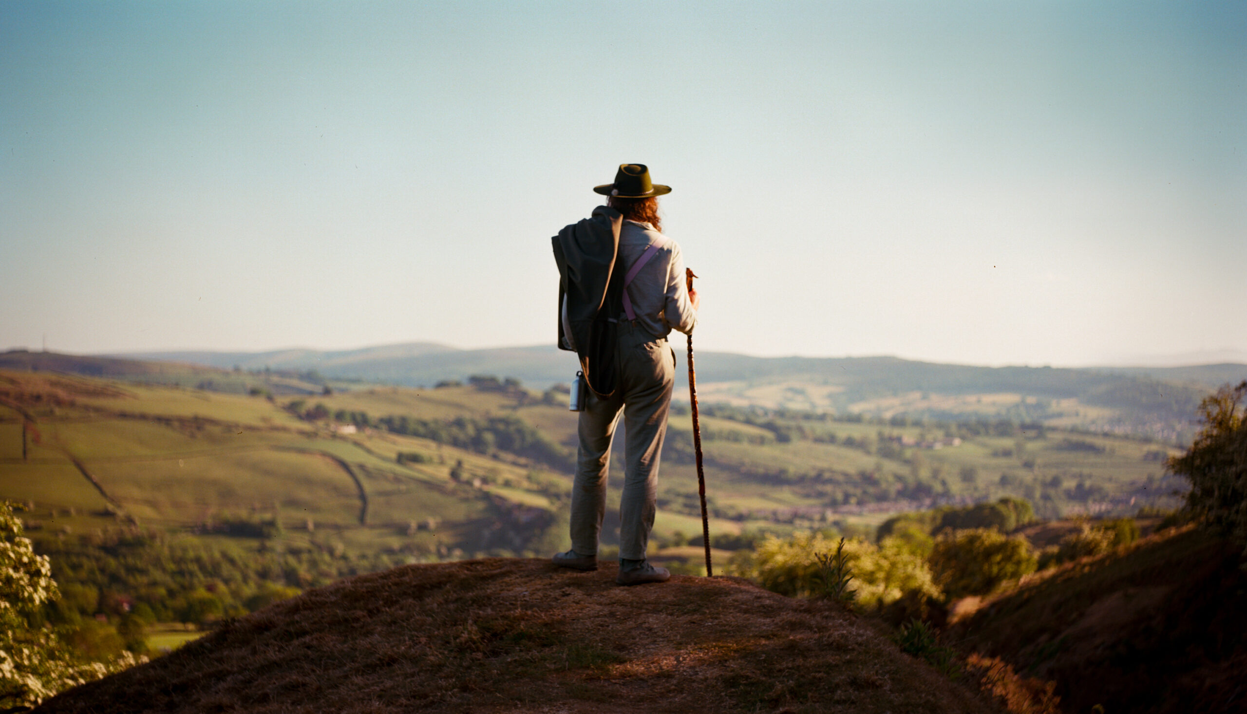 A man looking out over distant hills.
