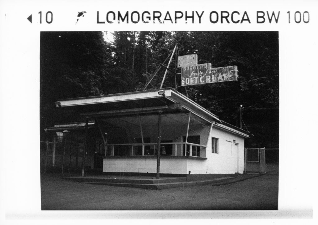 Black and white photo of a derelict hamburger stand