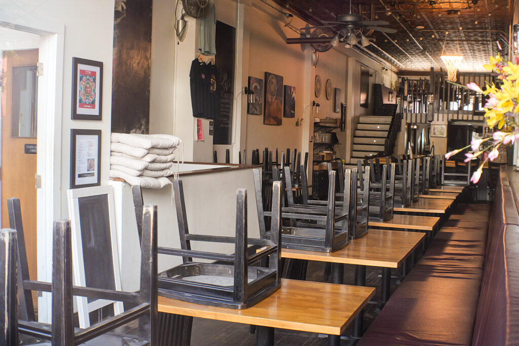 Chairs stacked on tables in a bar