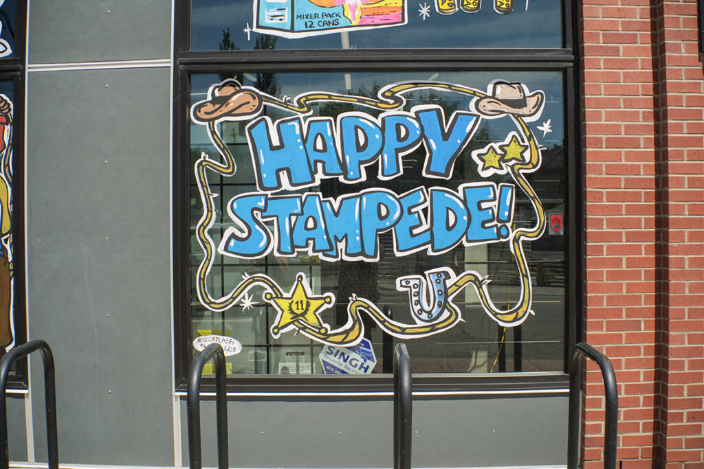 Happy Stampede painted on window