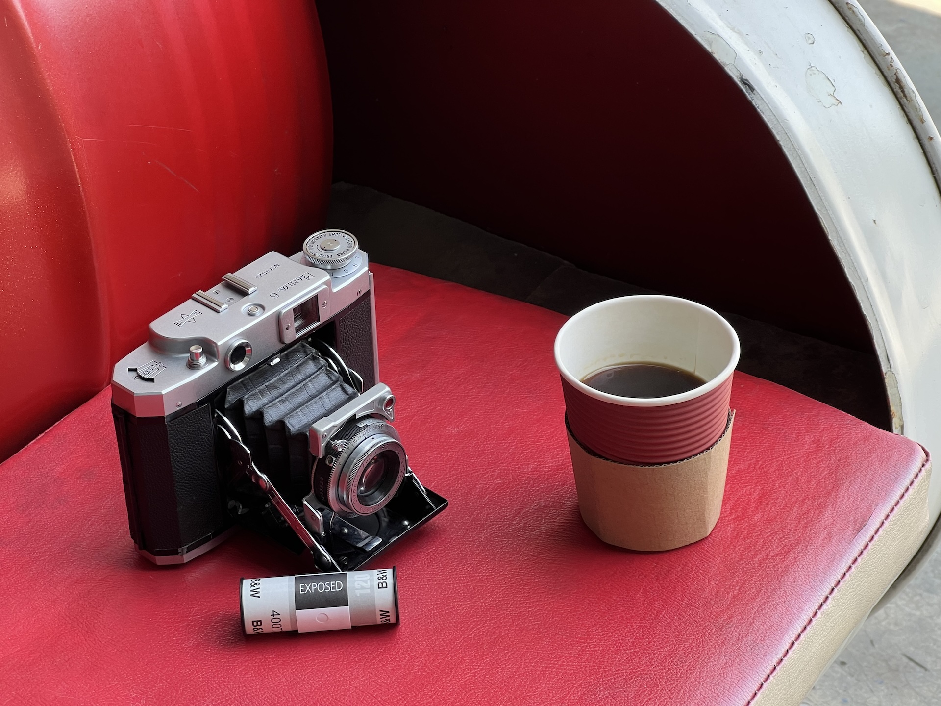 Mamiya Six IV, roll of exposed Tri-X film, and a cup of coffee