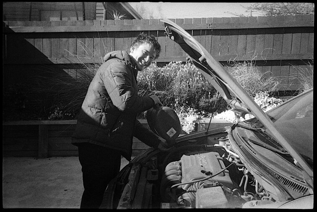 My grandson servicing his car.