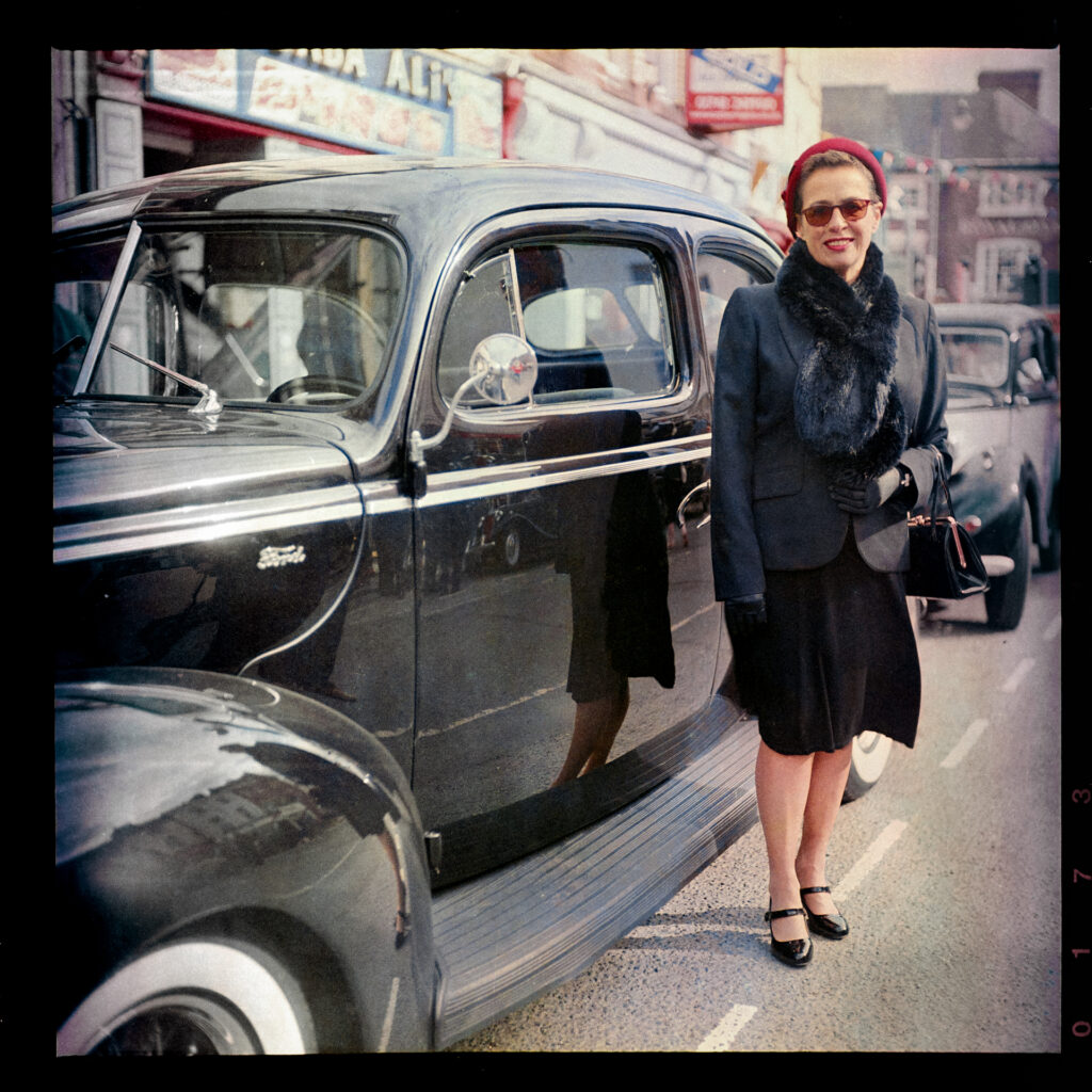 Lady in 1940s costume with vintage american car Taken with Yashica Mat EM and 47-year old Kodacolor 400 expired in 1997 rated at ISO12