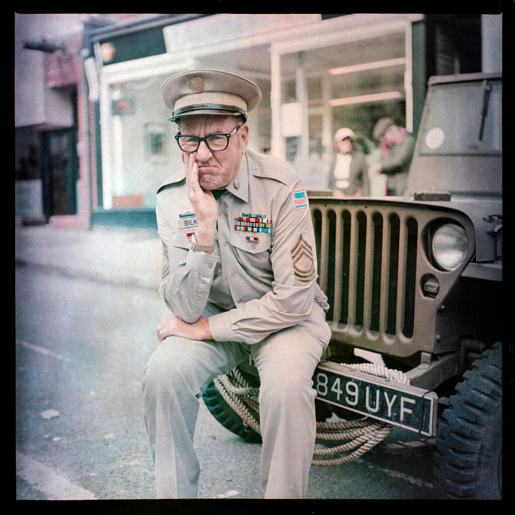 Man dressed as Sgt Bilko with world war 2 American jeepTaken with Yashica Mat EM and 47-year old Kodacolor 400 expired in 1997 rated at ISO12