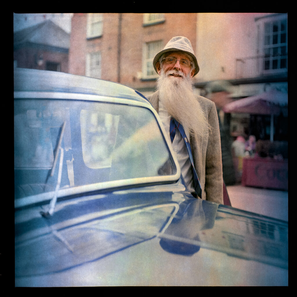 Man with long beard with 1940s car Taken with Yashica Mat EM and 47-year old Kodacolor 400 expired in 1997 rated at ISO12