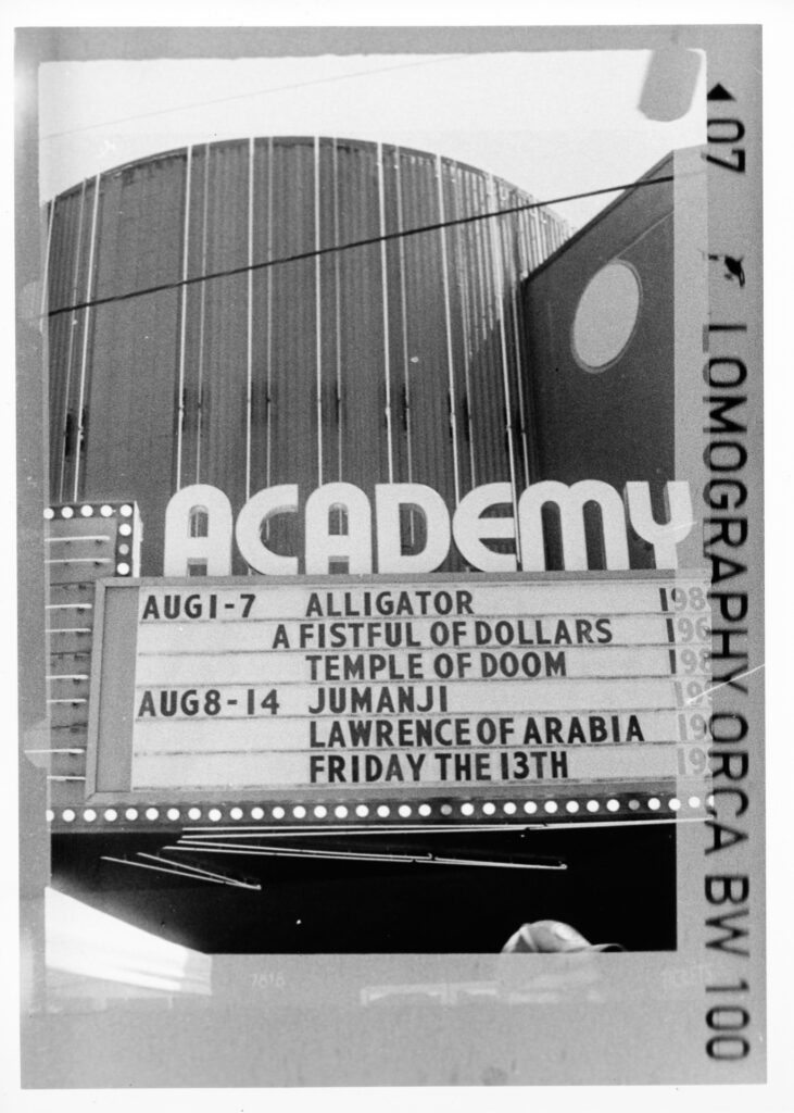 Black and white photo of a movie theater marquee
