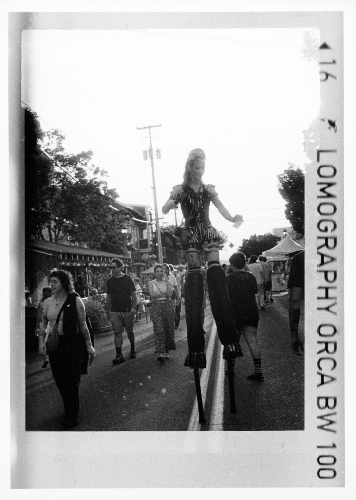 Black and white photo of a stiltwalker