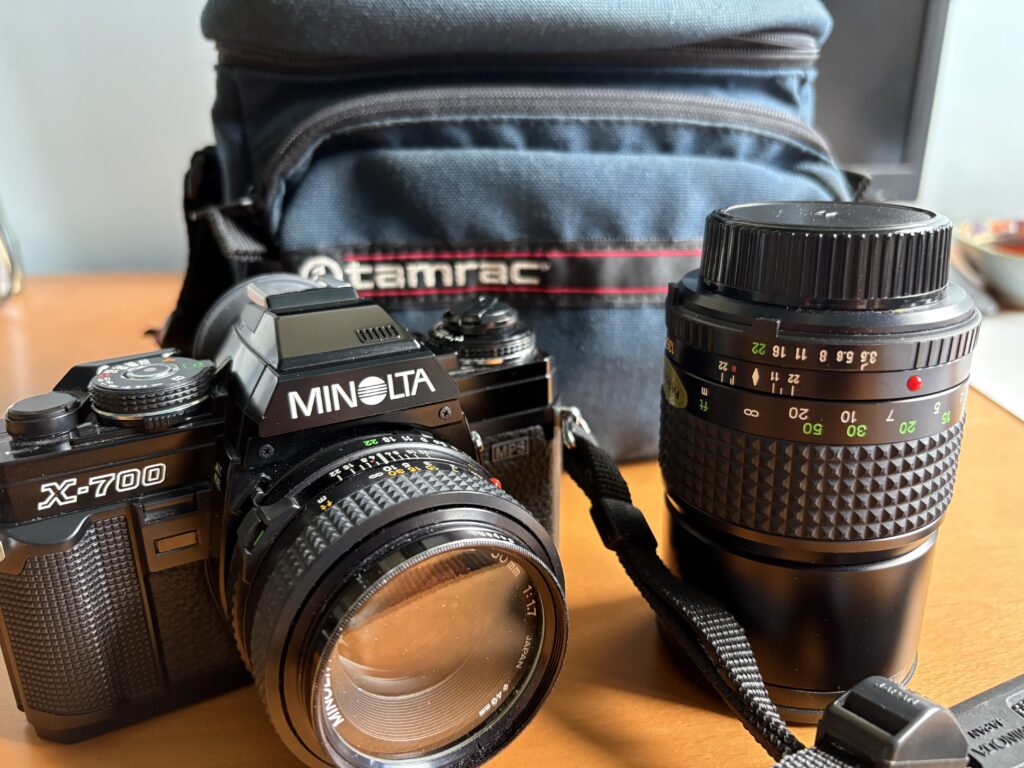 Minolta X700 SLR with two lenses and old camera bag.