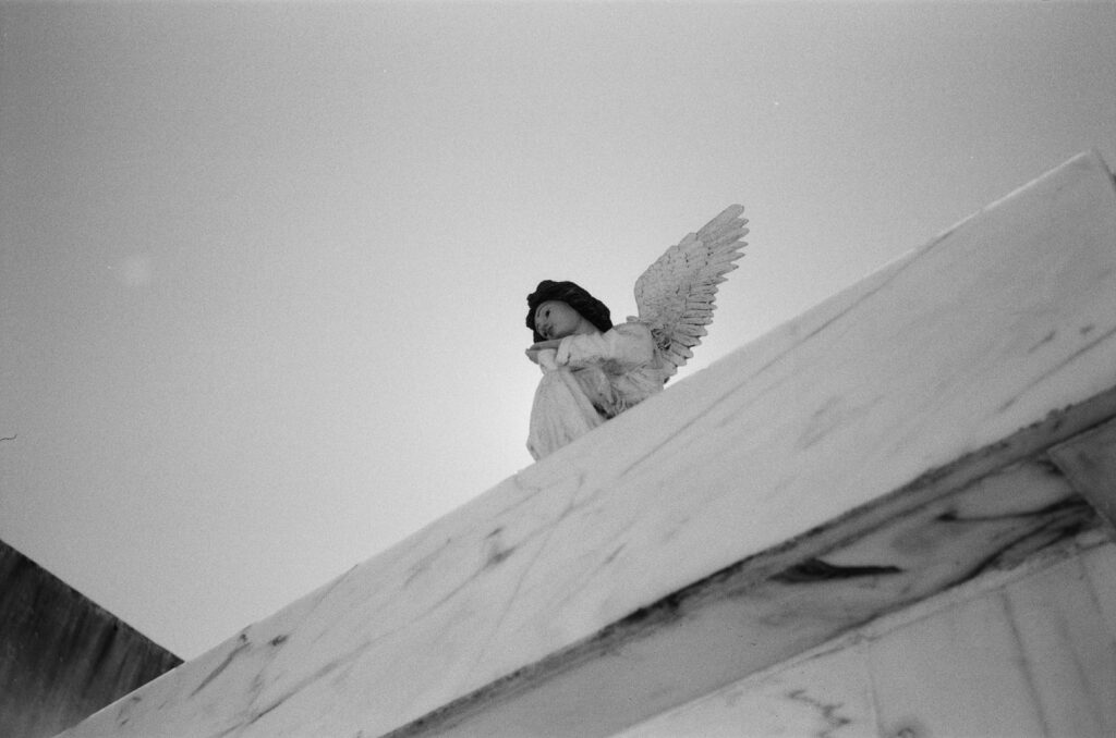 b&w photo of an angel on a mausoleum at Portimao cemetery.