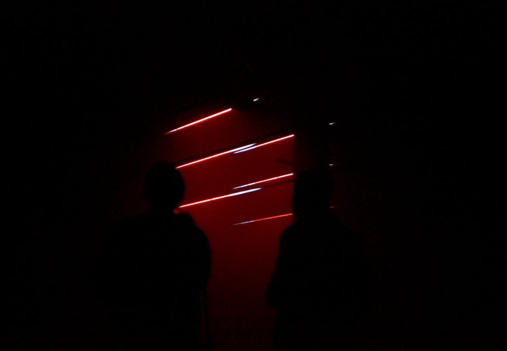 Couple silhouetted by light show