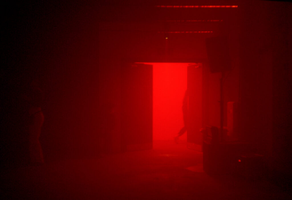 Man exiting red door