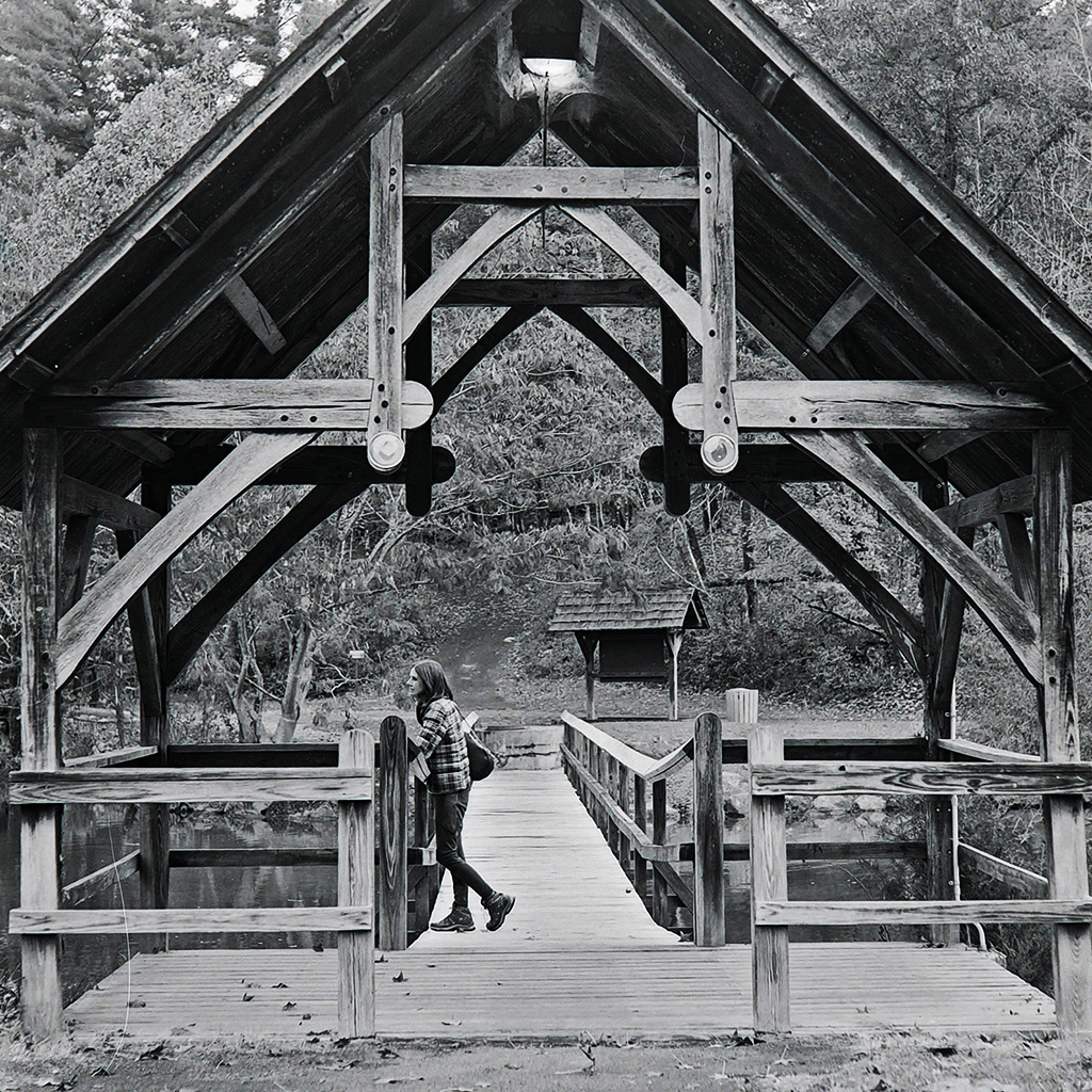 girl standing on a bridge in Steele Creek Park