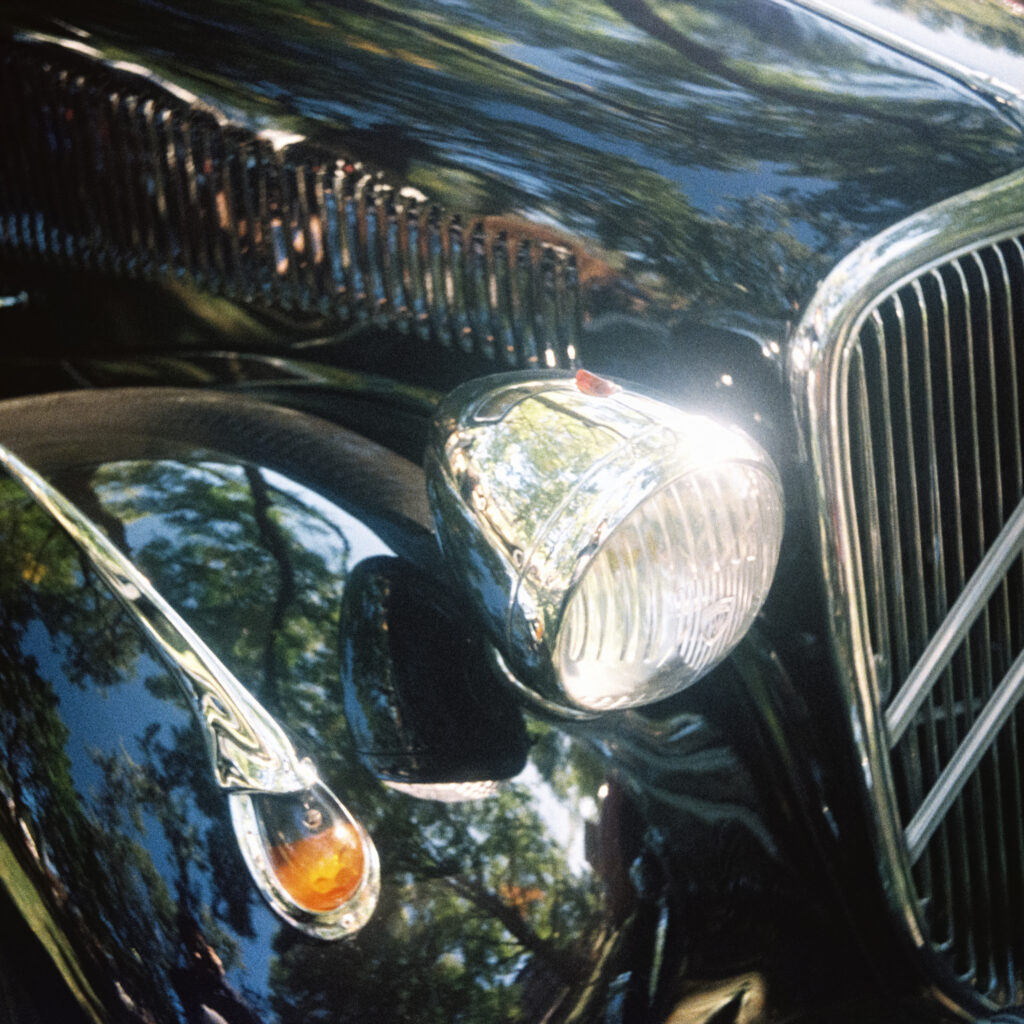 A close-up of a Citroën Traction Avant's headlight.