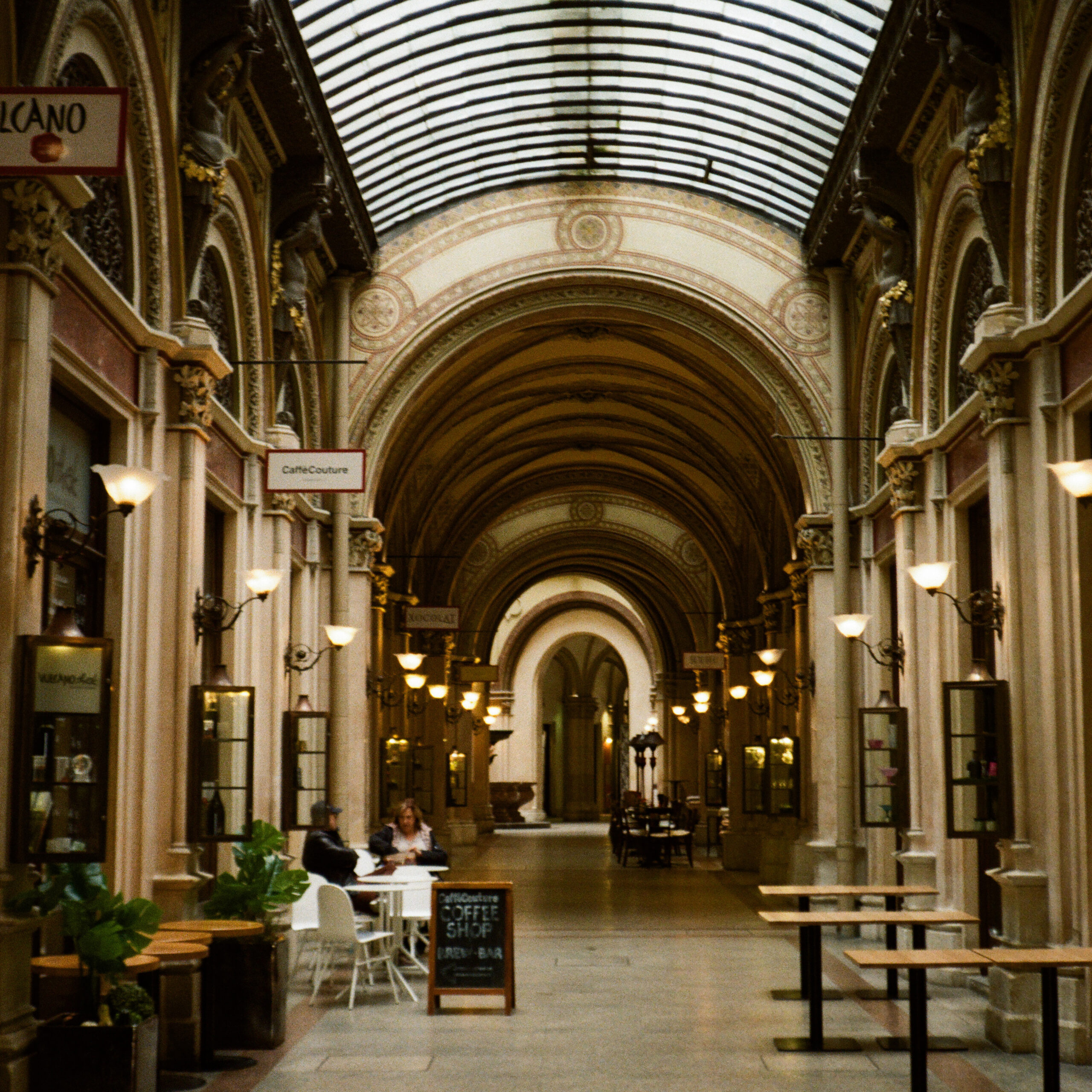 A square image of A Covered shopping arcade in the evening