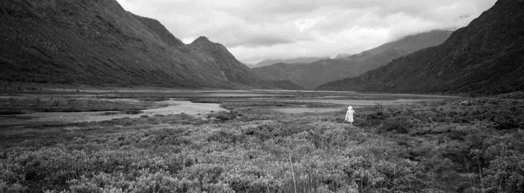 A small human in a black and white landscape in Norway shot on the Hasselblad XPan
