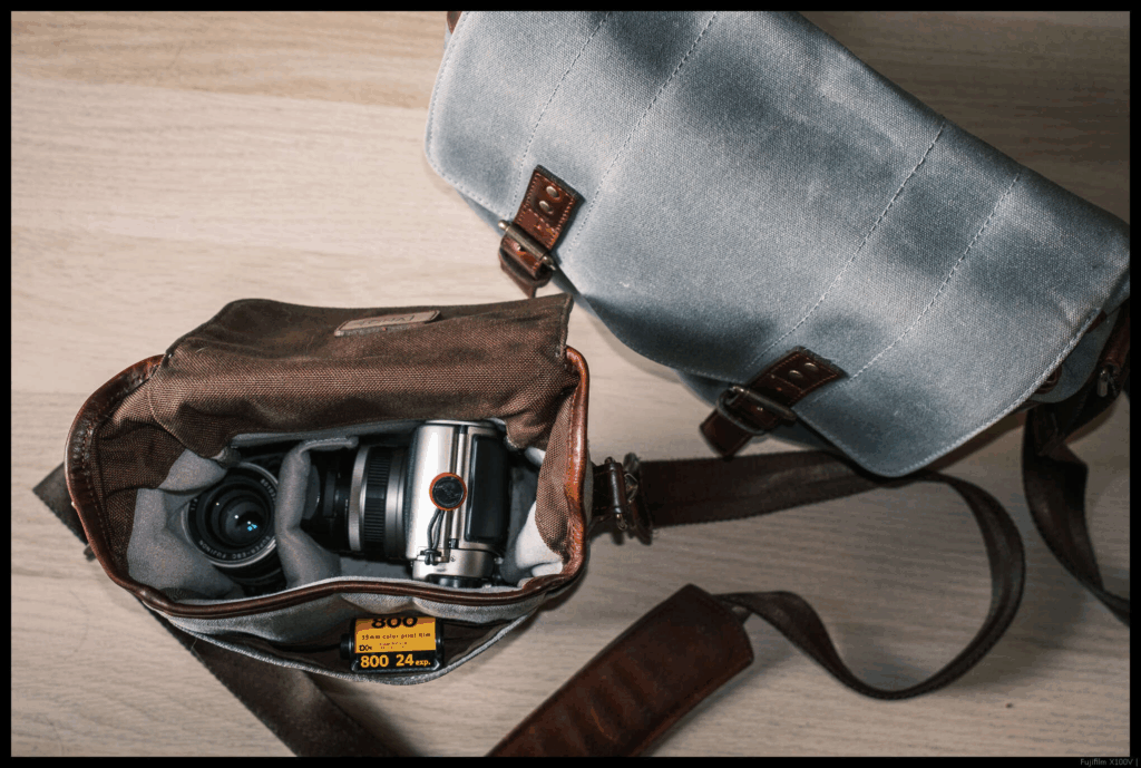 The Fujifilm TX-1 and a 30/5.6 stowed in a smaller camera bag, with the first camera bag visible above it for size comparison.