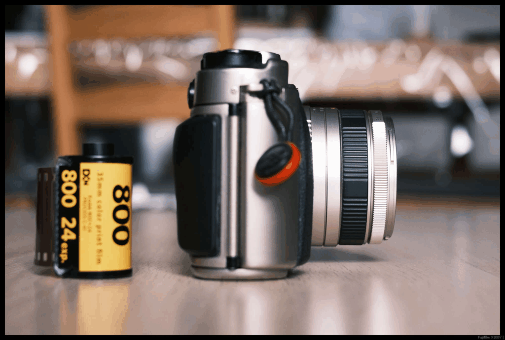 A image of the Fujifilm TX-1 with the 45/4 mounted from the side. A 35mm cassette is to the left.