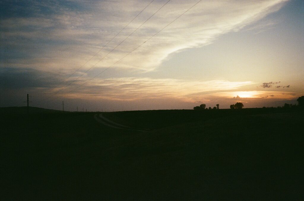 Back lit meadow at sunset with clouds