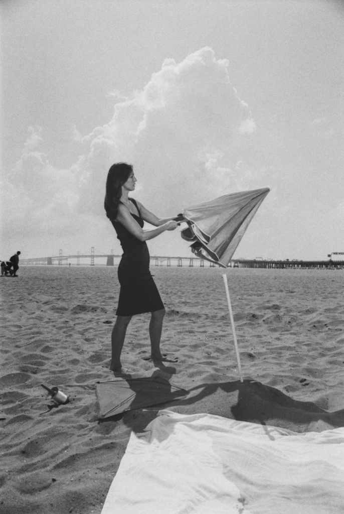 The actor and umbrella prop lit by the flash.