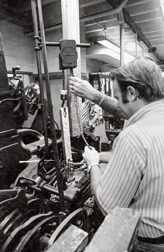hanging a lead ingot or 'pig' on a Linotype