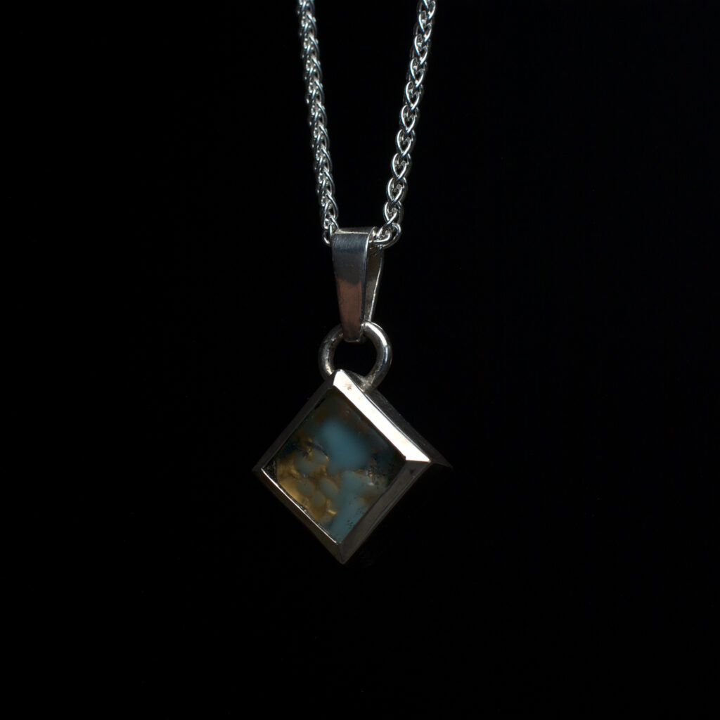 A pendant for a friend made by converting the remaining earring from a pair where one was lost.
