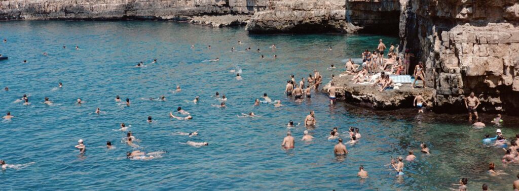 People swimming on the a warm summer day in Italy, shot on the Hasselblad Xpan and shot by Tom Kluijver