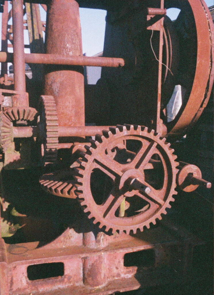 Old rusted crane gears on the quayside