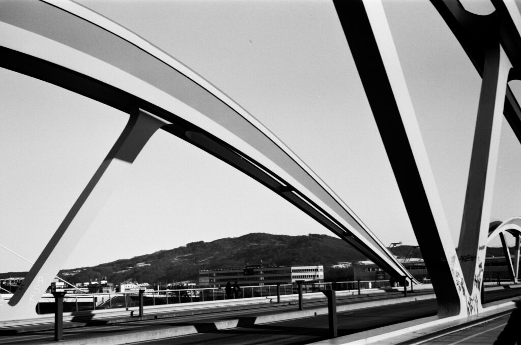 arcs os new railroad bridge with office buildings in the background 