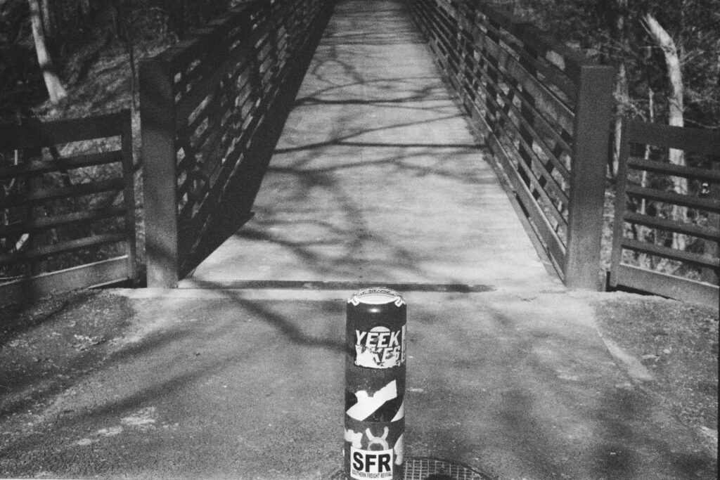 A bridge with a pole in the center foreground