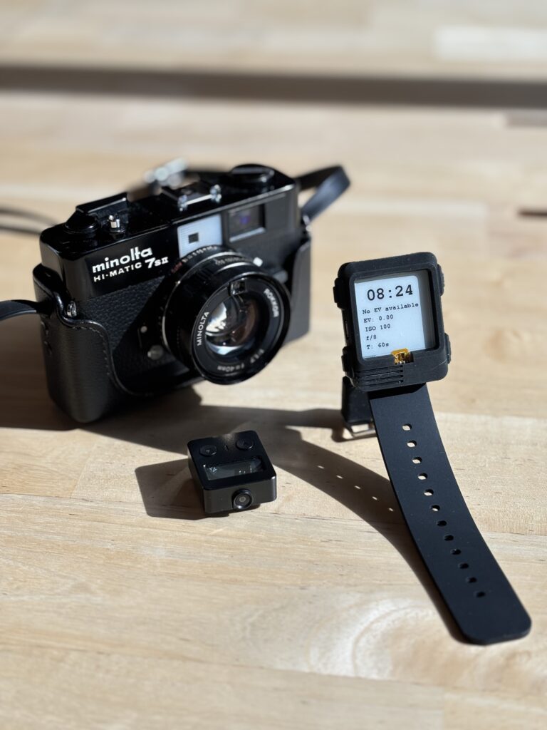 Minolta camera, next to first prototype of light meter watch