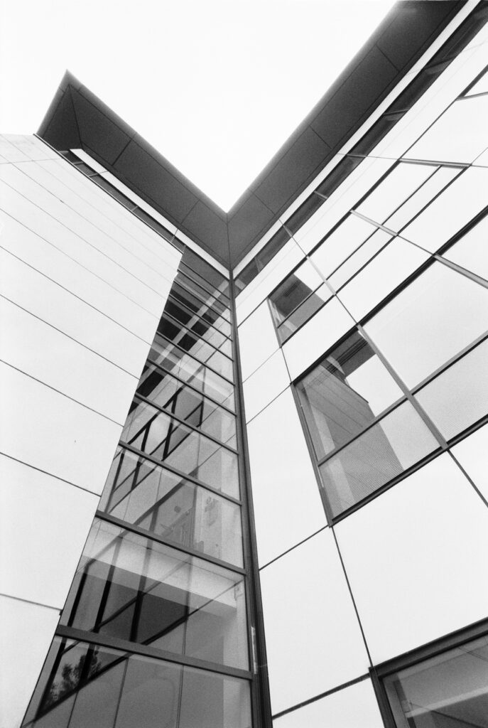 Wide angle view of an office building in black and white, looking up