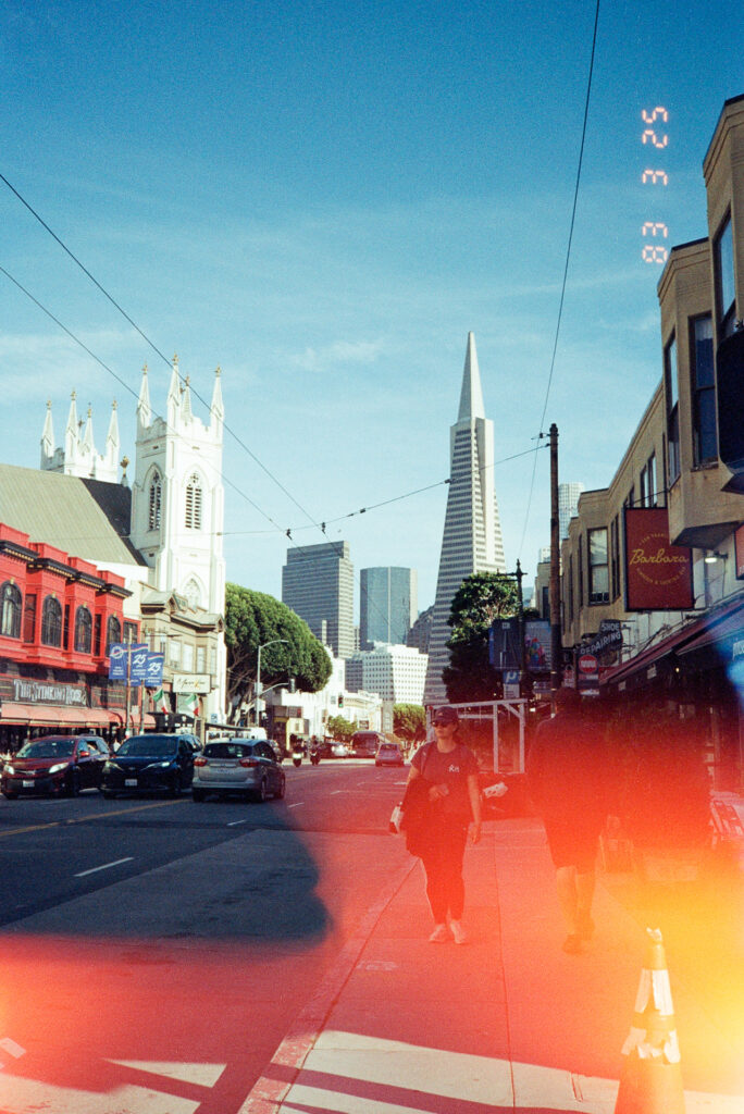 Photo looking down Columbus Ave from Stockton St in North Beach, San Francisco, California with the Transamerica Pyramid in the background