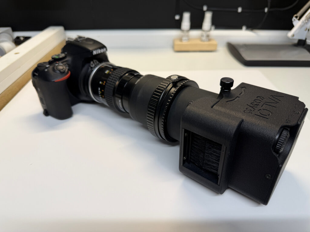 Light box connected to tubes, a lens and a digital camera