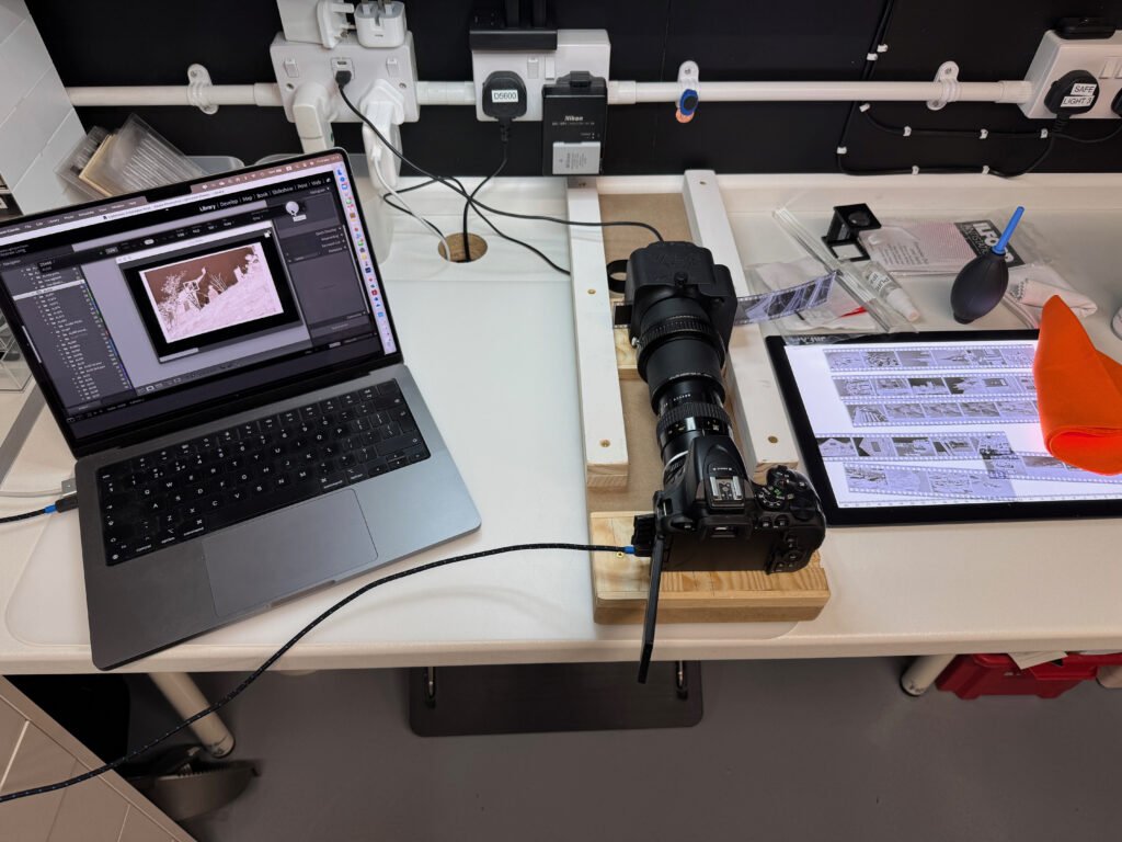 computer, camera with accessories and film on a light box