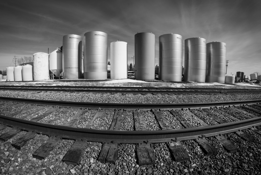 Canon 15mm fish-eye lens used to make photo of railway tracks and grain bins