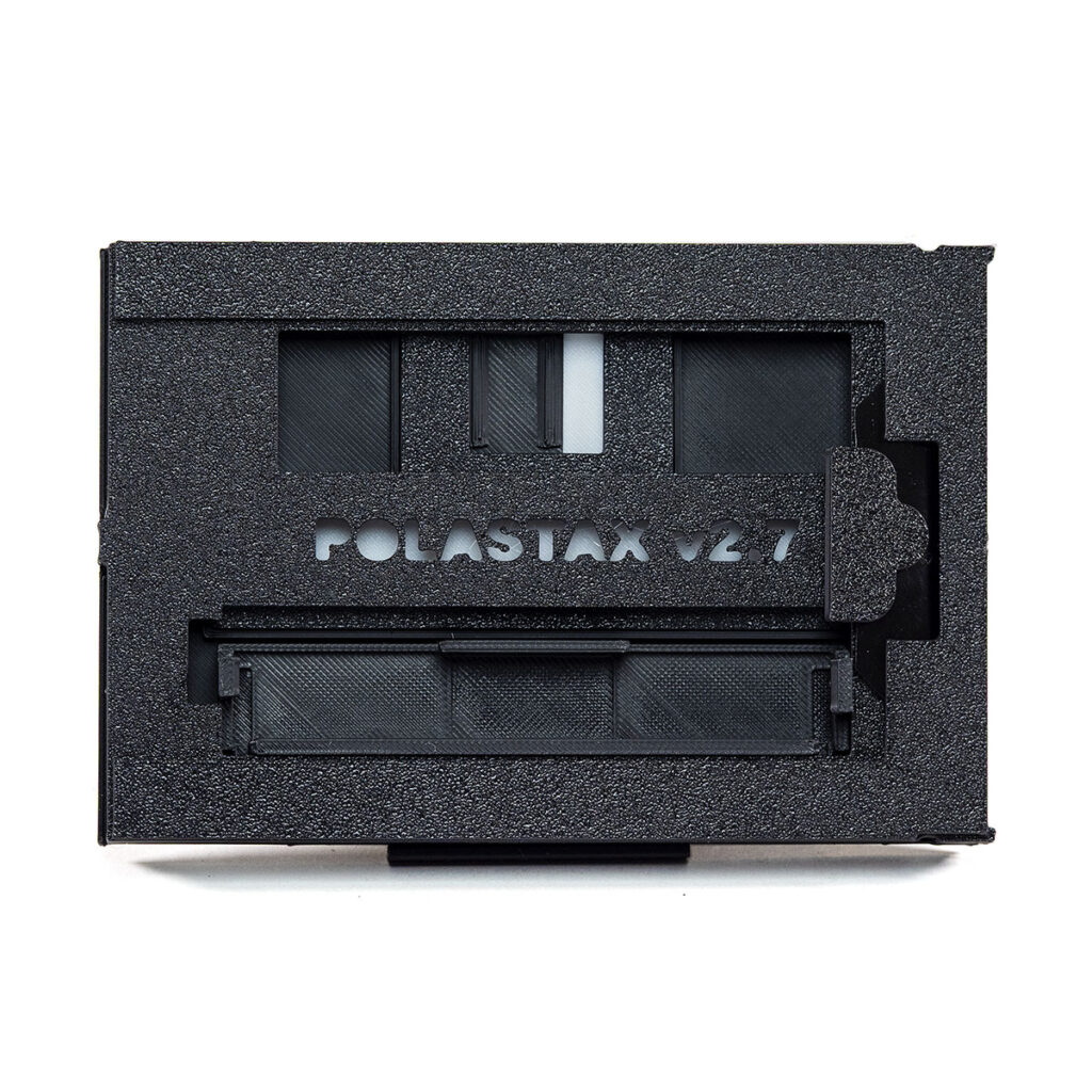 PolaStax Instax Wide film holder shown with the safety cap stowed and the dark slide closed.