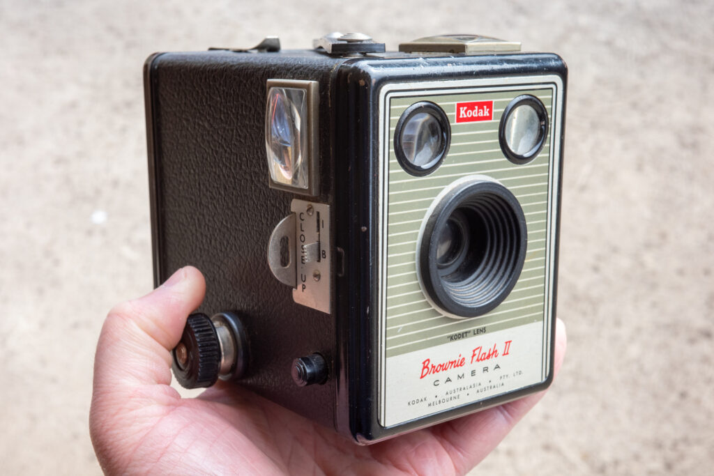Photo of a hand holding a box camera - Kodak Brownie Flash II