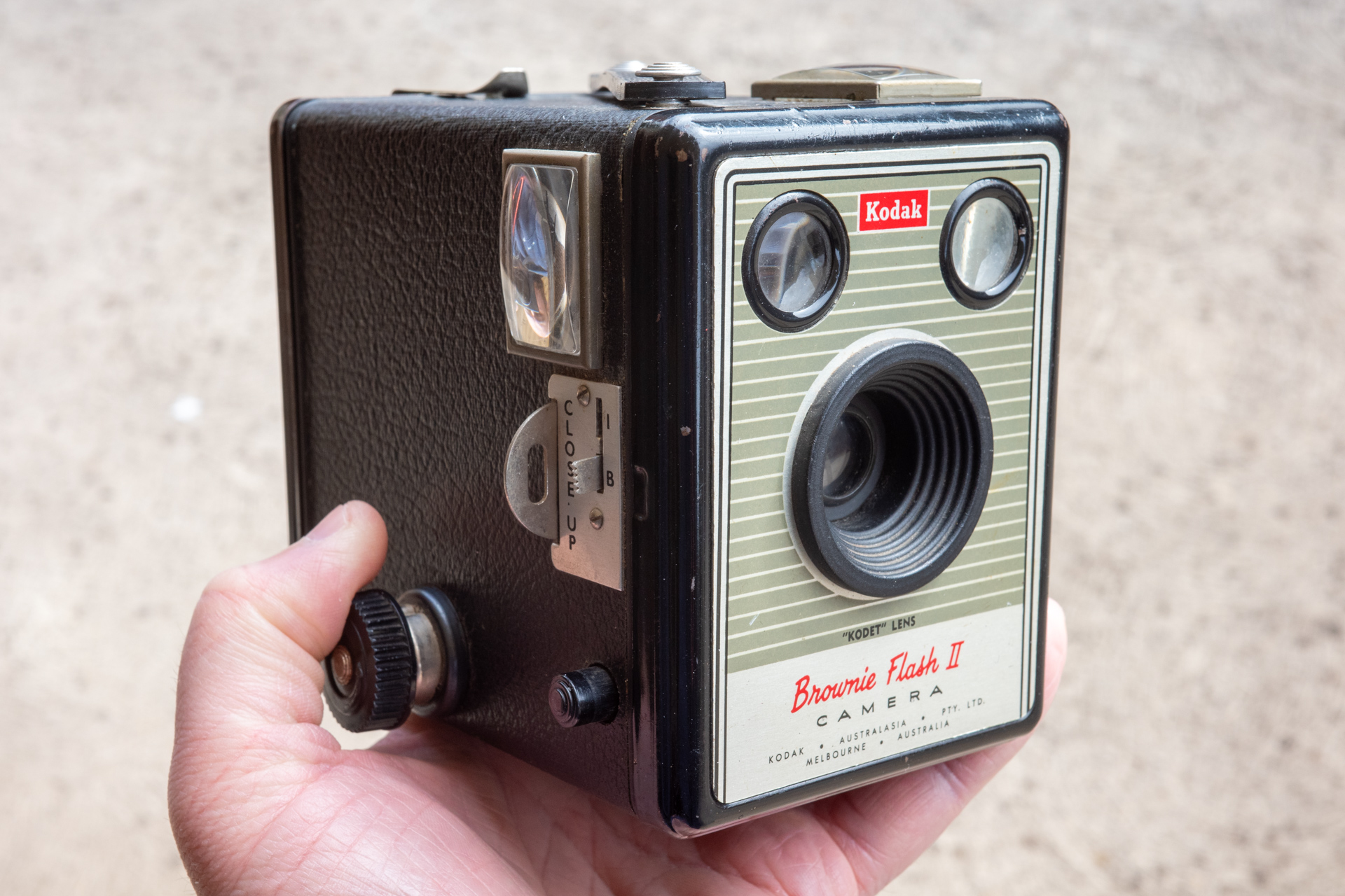 Photo of a hand holding a box camera - Kodak Brownie Flash II