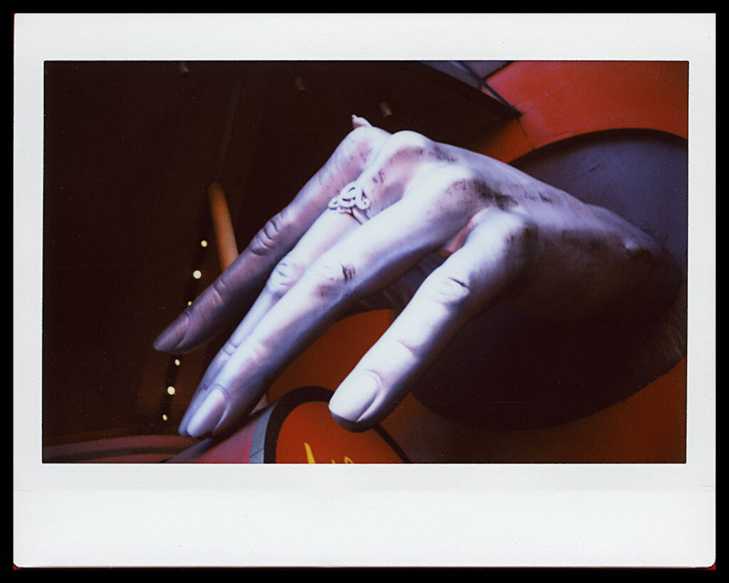 Instax Wide image of giant hand in front of Madame Tussaud's Wax Museum on 42nd Street.