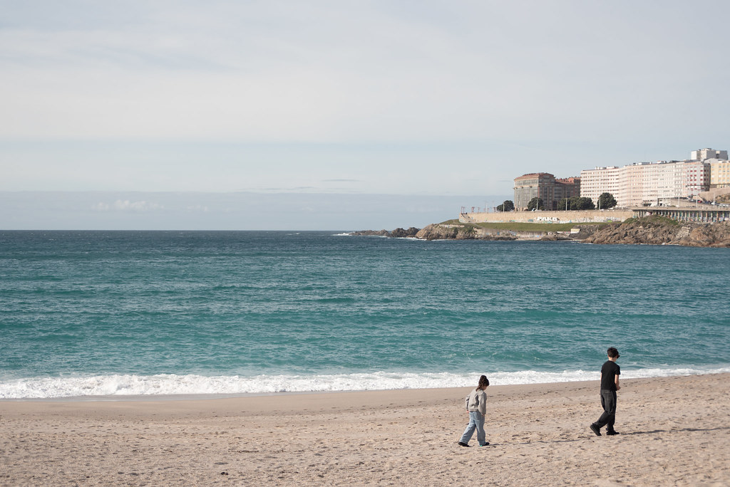 Two children walk away from the beach