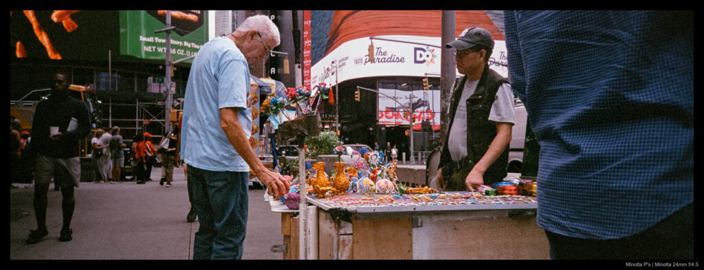 A passerby inspects a street vendor's wares near Times Square.