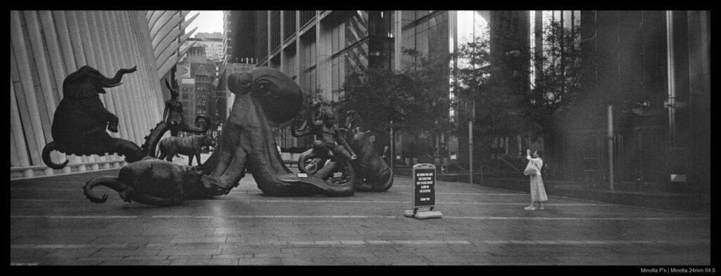Someone snaps a photo of an odd art sculpture near the Oculus.